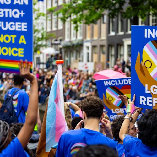 The Netherlands. LGBTIQ+ refugees and asylum seekers celebrate Pride on UNHCR’s boat during the Amsterdam Canal Parade 2023.