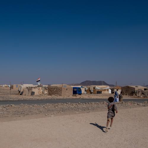 Yemen. An internally displaced boy running in an IDP site